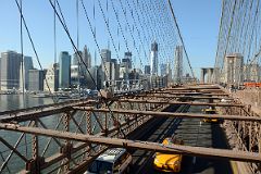 15 Cars Crossing The New York Brooklyn Bridge Under The Pedestrian Walkway With The Financial District Beyond
